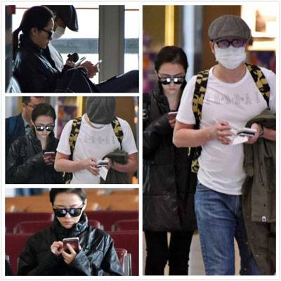 张靓颖冯轲现身机场 一路玩手机变无交流